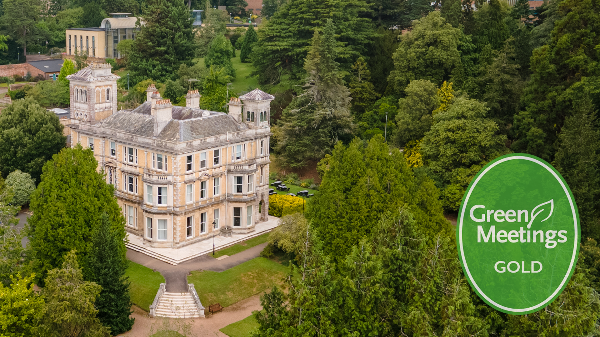 drone shot of Exeter University Campus surrounded by trees